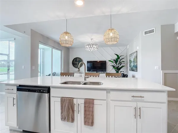 a kitchen with cabinets stainless steel appliances and a counter space