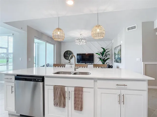 a kitchen with cabinets stainless steel appliances and a counter space