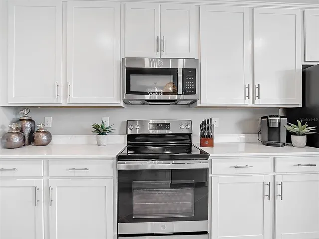 a view of a dining room with furniture and a window