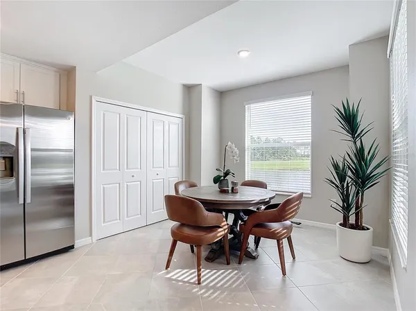 a living room with furniture a chandelier and a flat screen tv