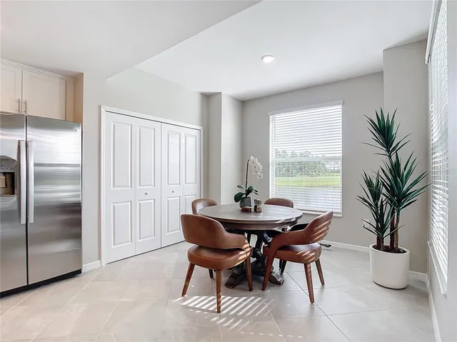 a living room with furniture a chandelier and a flat screen tv