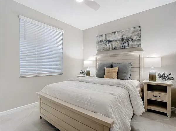 a bed room with a bed and a chair