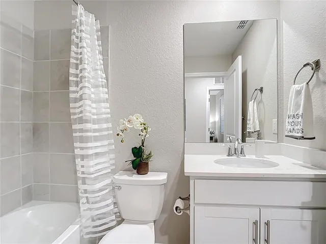 a bedroom with a bed and a lamp