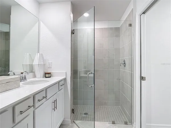 a bathroom with a glass shower door