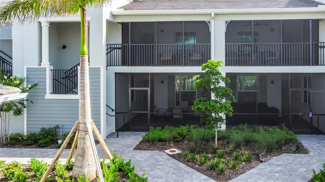 a view of a patio with table and chairs and potted plants by side of it