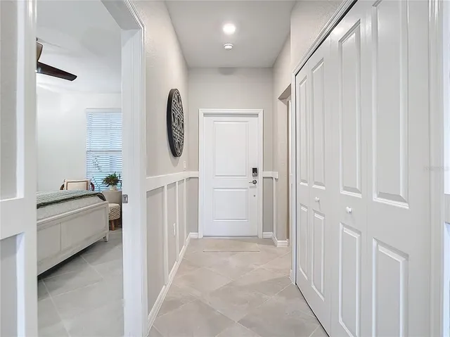 a living room with kitchen island furniture and a chandelier