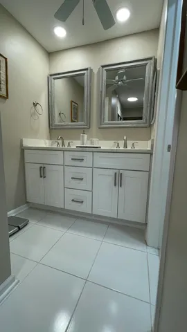 a bathroom with a double vanity sink and a mirror
