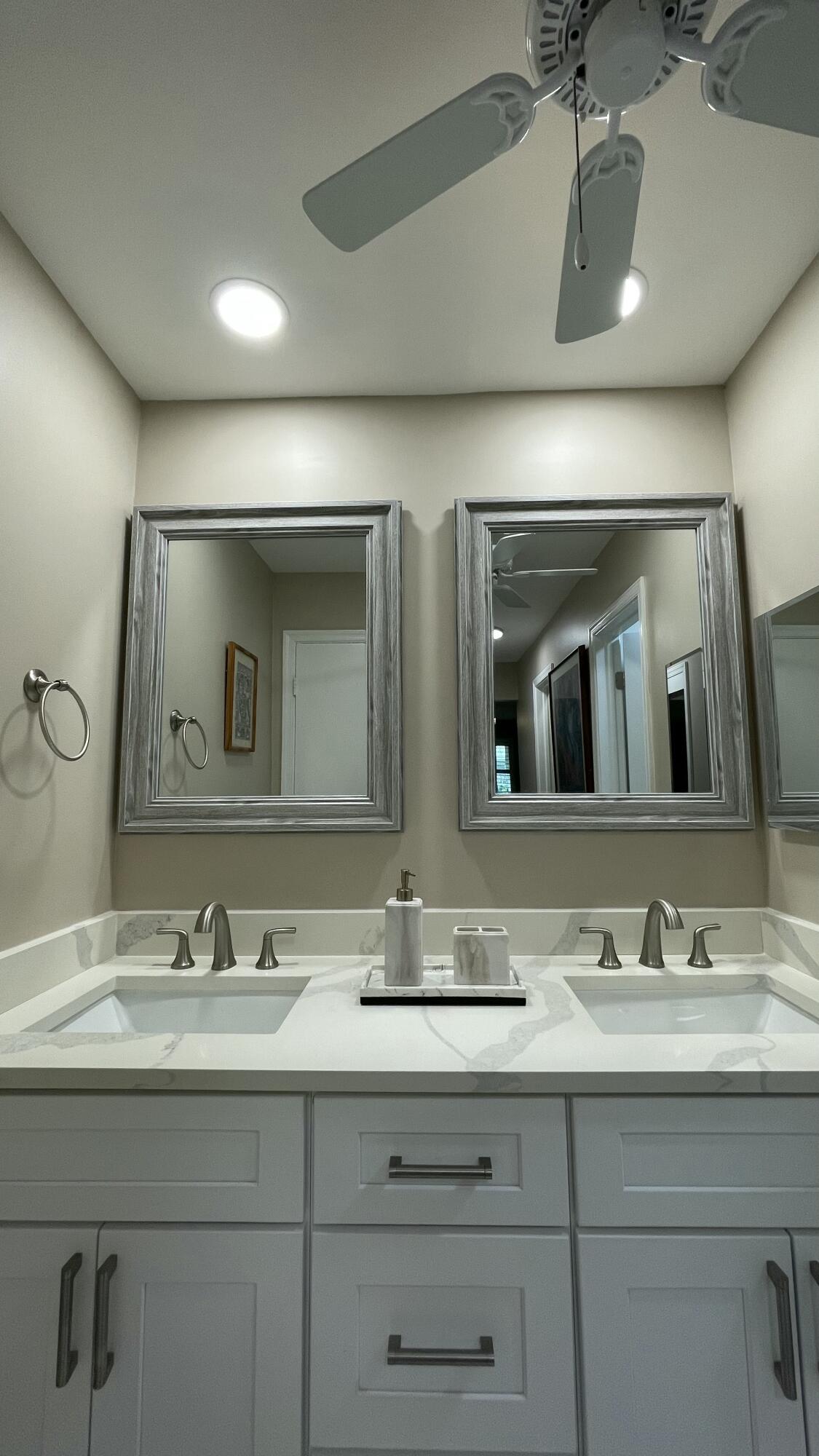10140 South 44th Drive, Unit 372 Boynton Beach, FL 33436 - Photo 15 of 19 a bathroom with a double vanity sink and a mirror