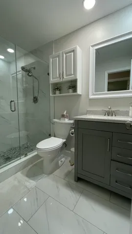 a bathroom with a toilet and a shower