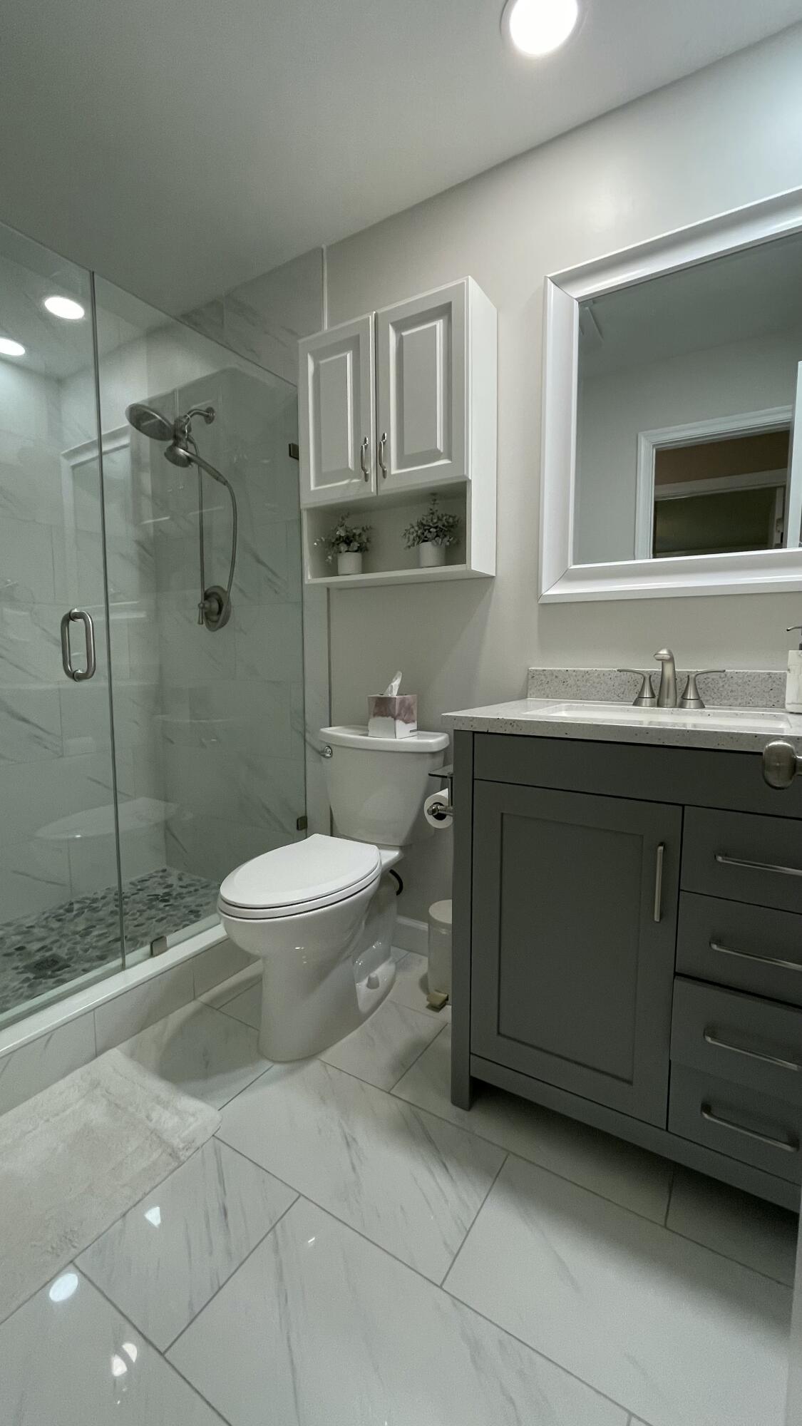 10140 South 44th Drive, Unit 372 Boynton Beach, FL 33436 - Photo 16 of 19 a bathroom with a toilet sink and shower
