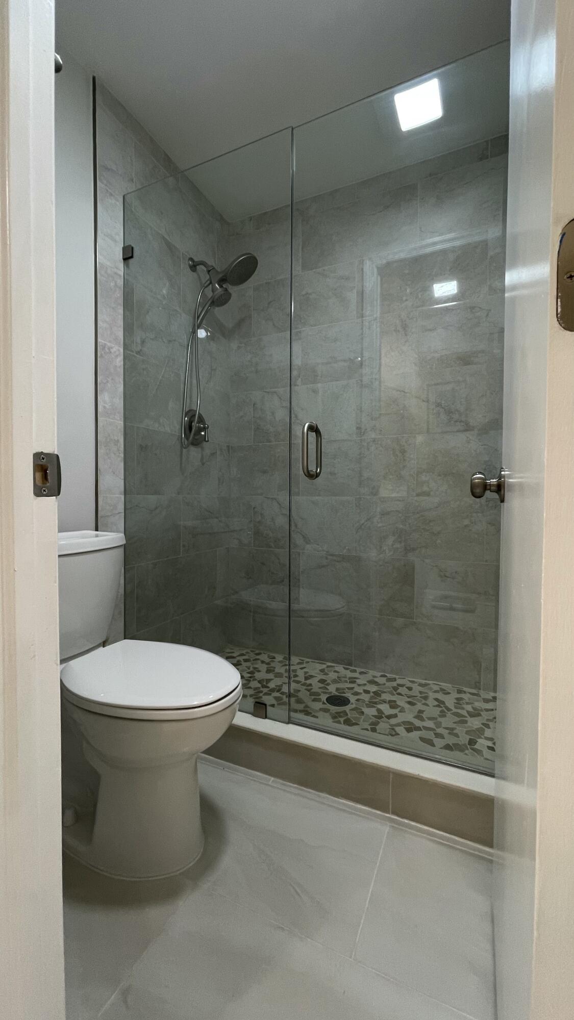 10140 South 44th Drive, Unit 372 Boynton Beach, FL 33436 - Photo 17 of 19 a bathroom with a toilet and a shower