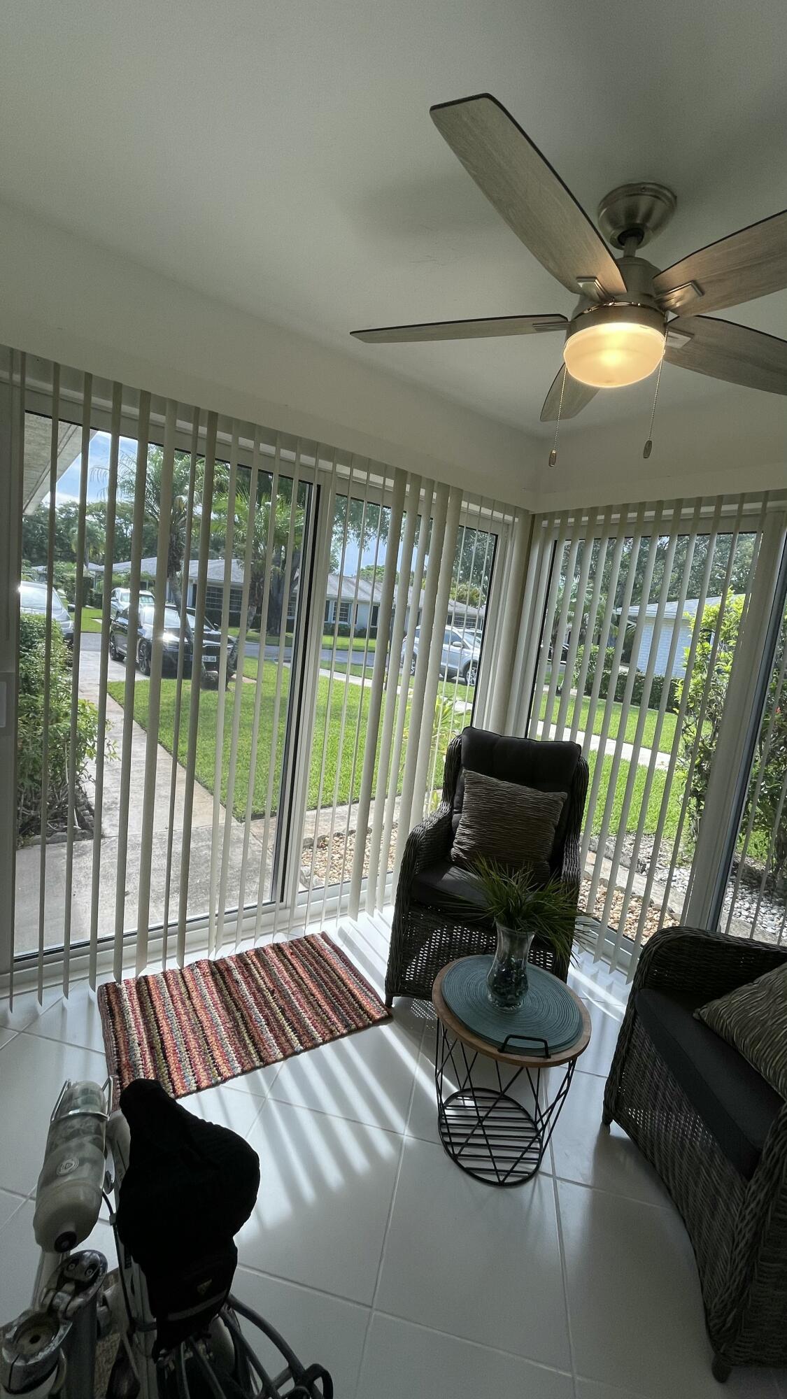 10140 South 44th Drive, Unit 372 Boynton Beach, FL 33436 - Photo 18 of 19 a living room with furniture and a floor to ceiling window