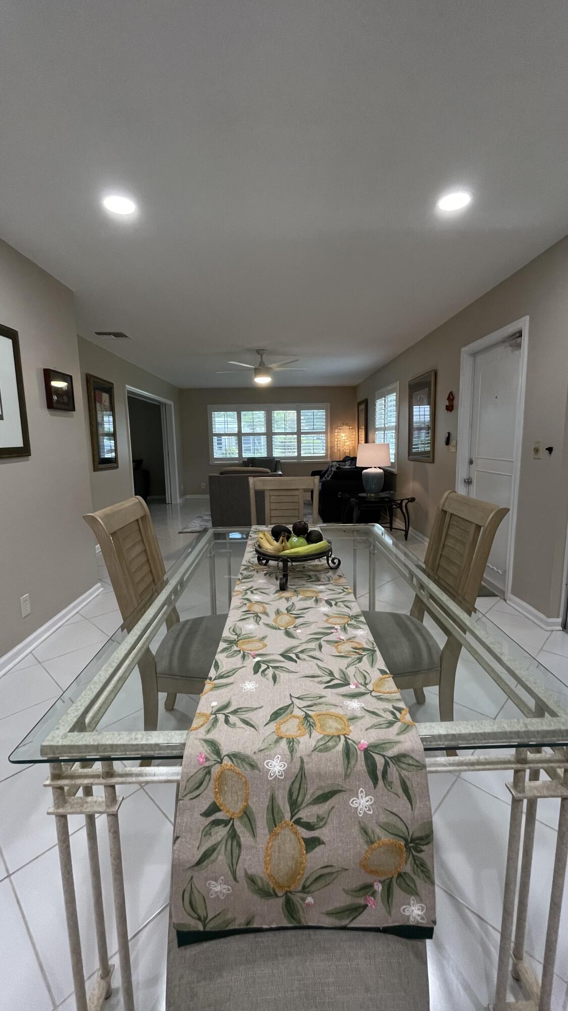 10140 South 44th Drive, Unit 372 Boynton Beach, FL 33436 - Photo 3 of 19 a living room with furniture and a flat screen tv