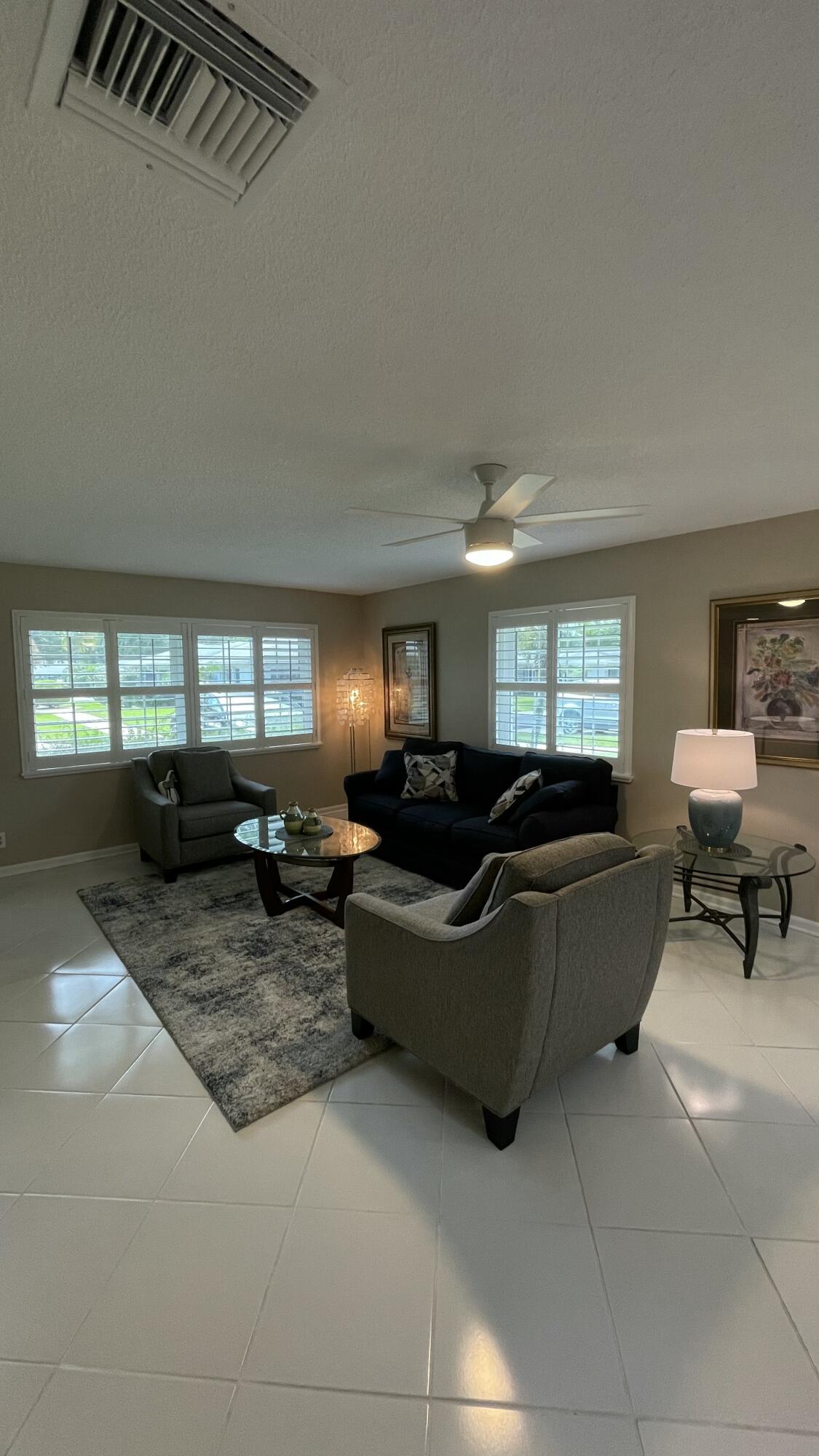 10140 South 44th Drive, Unit 372 Boynton Beach, FL 33436 - Photo 4 of 19 a living room with furniture and a window