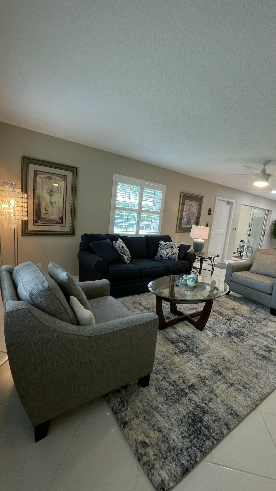 10140 South 44th Drive, Unit 372 Boynton Beach, FL 33436 - Photo 5 of 19 a living room with furniture and a window