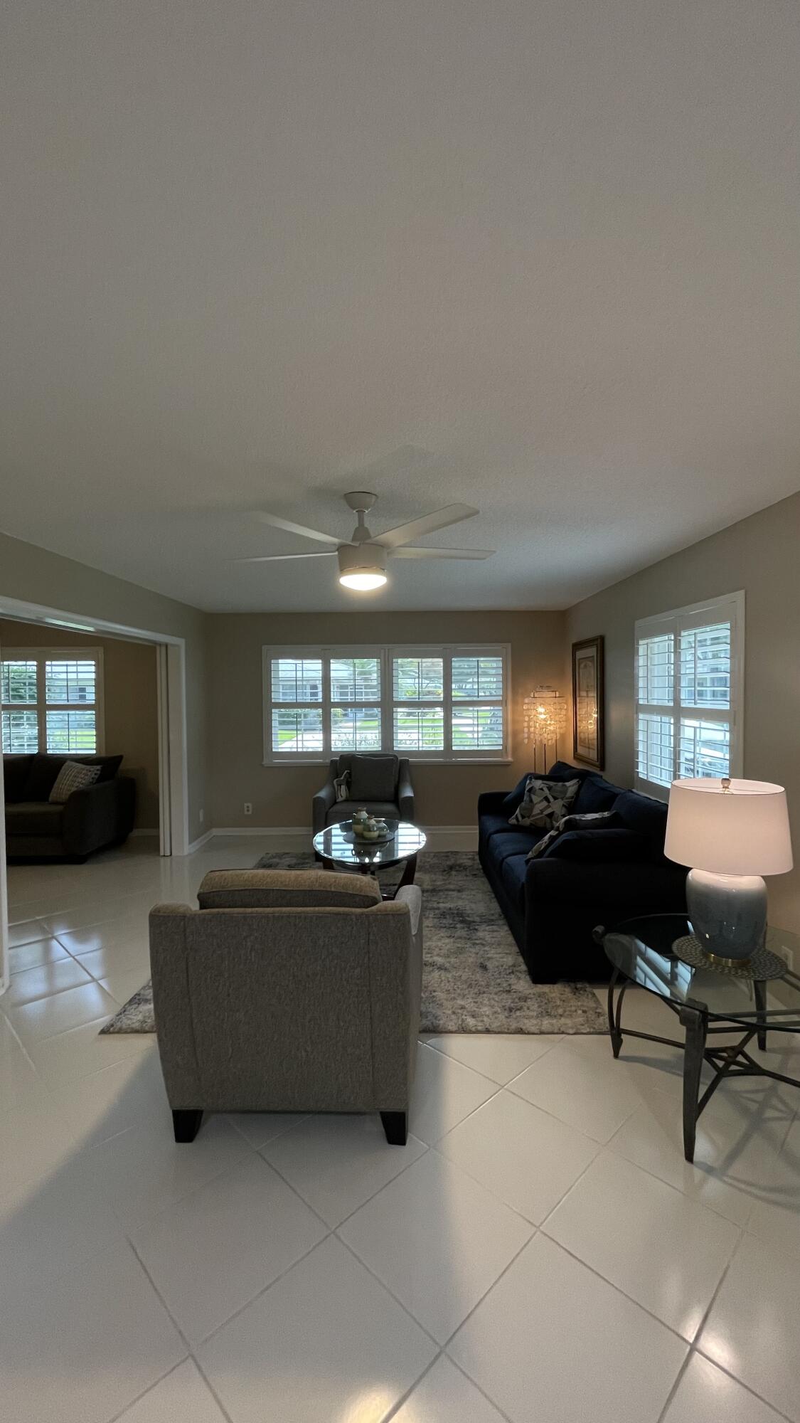 10140 South 44th Drive, Unit 372 Boynton Beach, FL 33436 - Photo 7 of 19 a living room with furniture and a flat screen tv