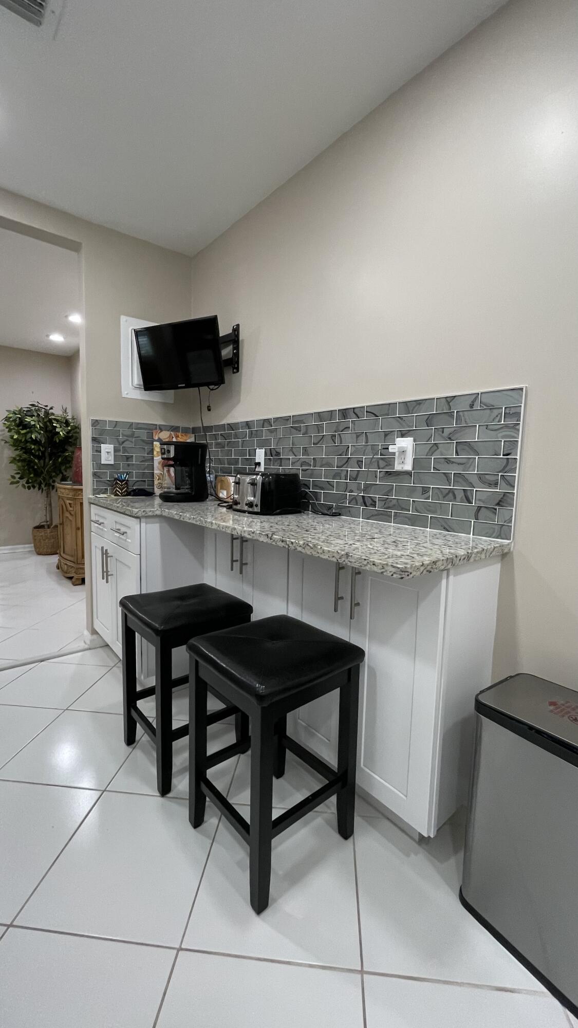 10140 South 44th Drive, Unit 372 Boynton Beach, FL 33436 - Photo 10 of 19 a kitchen with a sink a microwave and cabinets