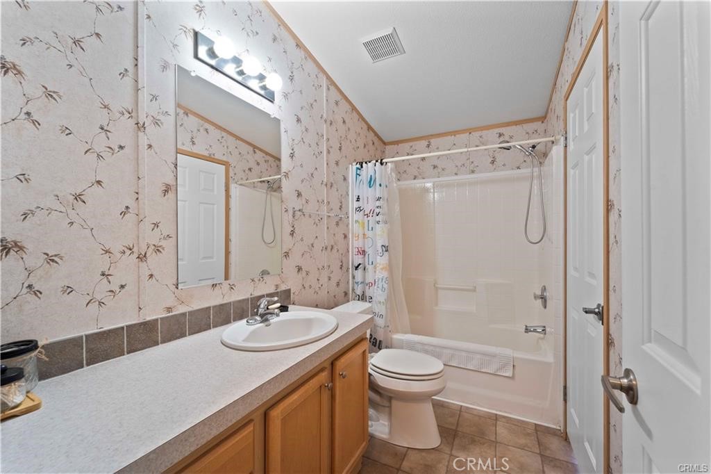 34232 Maui Road Newberry Springs, CA 92365 - Photo 20 of 35 a bathroom with a sink a toilet a mirror and shower