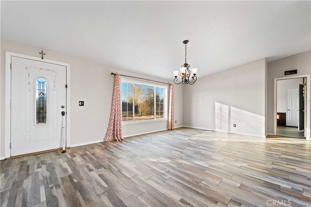 34232 Maui Road Newberry Springs, CA 92365 - Photo 28 of 35 a view of an empty room with wooden floor and a window