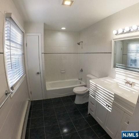 71 Gordon Street Ridgefield Park, NJ 07660 - Photo 13 of 20 a bathroom with a sink a toilet and shower
