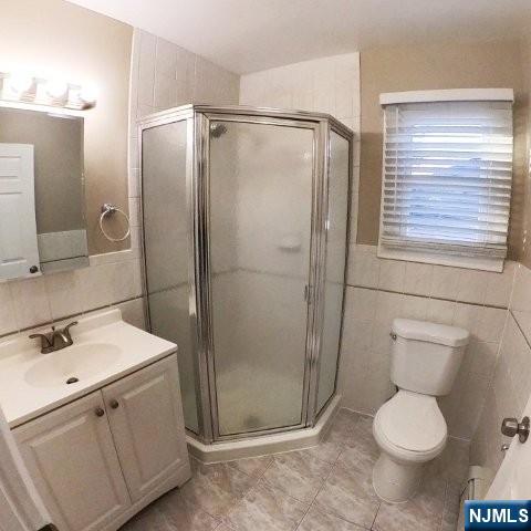 71 Gordon Street Ridgefield Park, NJ 07660 - Photo 20 of 20 a bathroom with a shower sink vanity and toilet