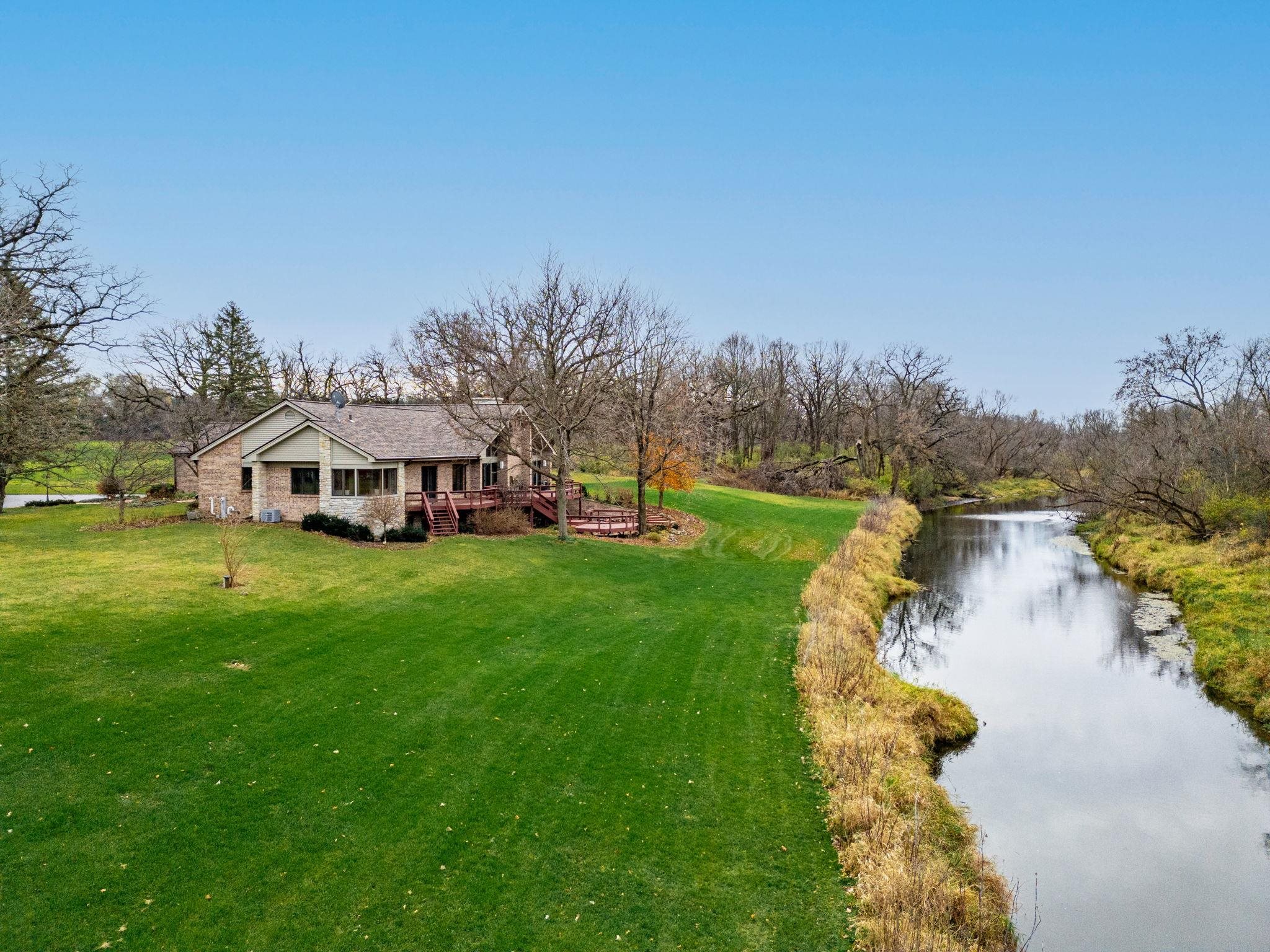 8634 North Kilbuck Road Monroe Center, IL 61052 - Photo 2 of 50 a view of a house with garden and a yard