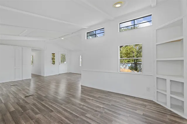 wooden floor in an empty room with a window