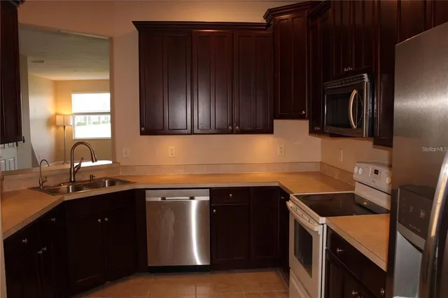 a kitchen with a sink and a stove top oven