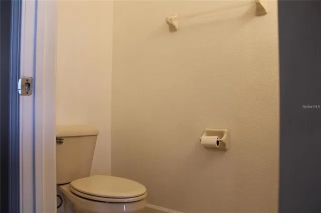 a white toilet sitting next to a shower