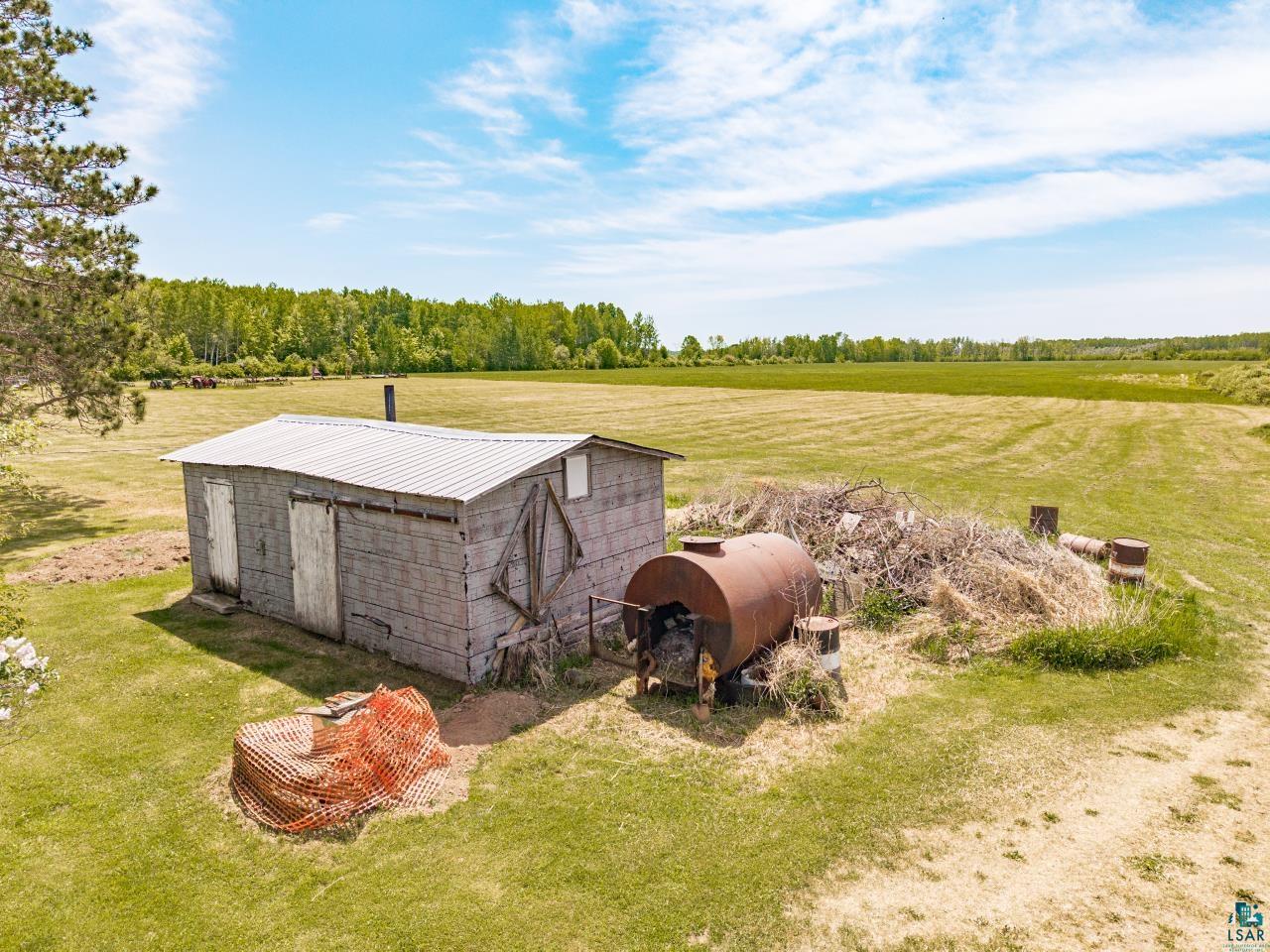 6606 Metso Road Kettle River, MN 55757 - Photo 42 of 84 Rural property featuring a storage shed with a corrugated metal roof and a wooden exterior