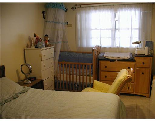 5852 South Rue Road West Palm Beach, FL 33415 - Photo 5 of 7 a bedroom with a bed and large windows