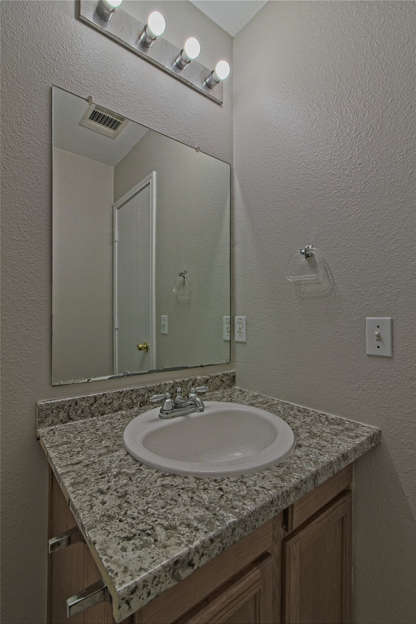 232 Brickyard Lane Jarrell, TX 76537 - Photo 25 of 31 A well-appointed bathroom with granite counters and a practical vanity setup.