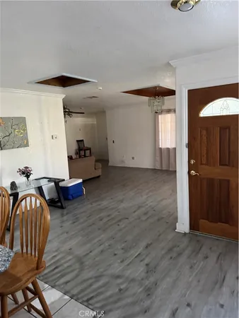 a view of a livingroom with furniture and hardwood floor