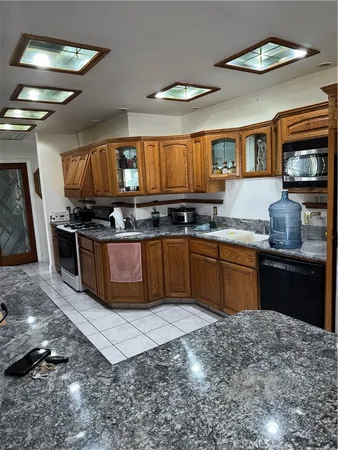 a kitchen with stainless steel appliances granite countertop a stove a sink dishwasher and cabinets