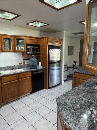 a kitchen with stainless steel appliances granite countertop a refrigerator and a stove