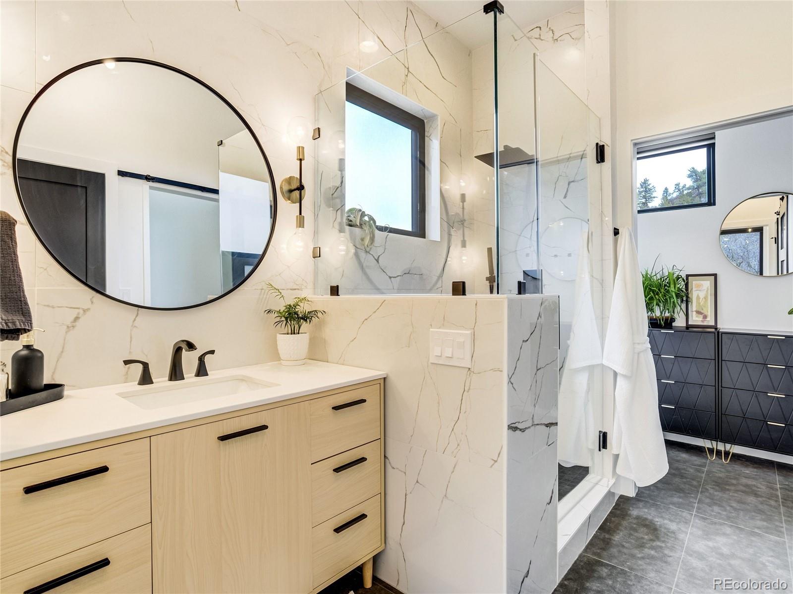 284 Crystal Park Road Manitou Springs, CO 80829 - Photo 4 of 39 a bathroom with a sink vanity and a mirror