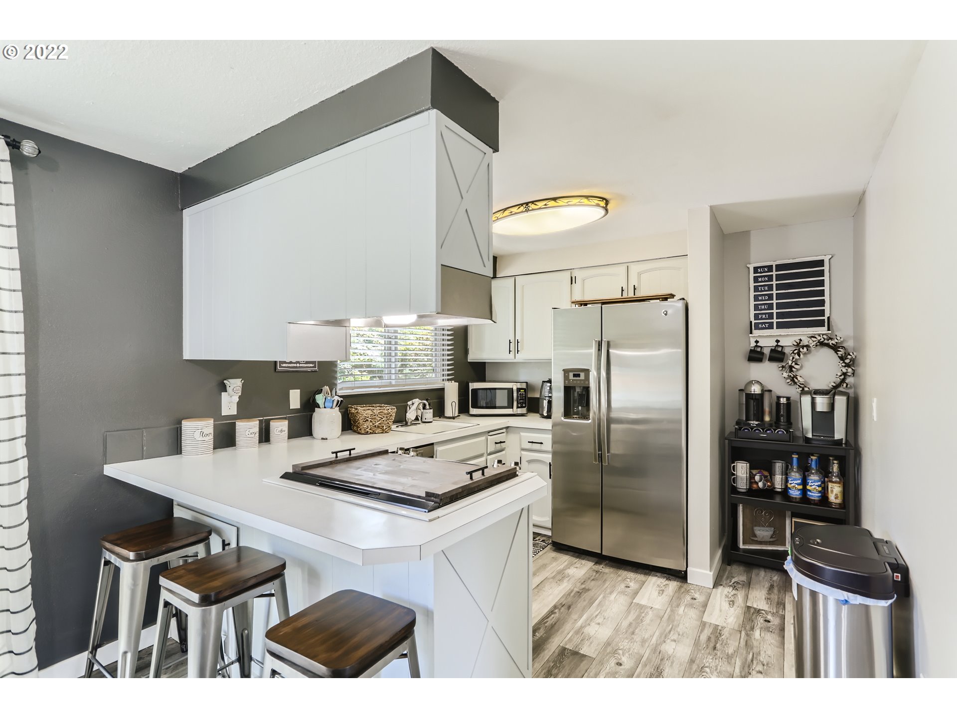 490 Southwest 4th Street Gresham, OR 97080 - Photo 11 of 30 a kitchen with stainless steel appliances a stove a refrigerator and a refrigerator