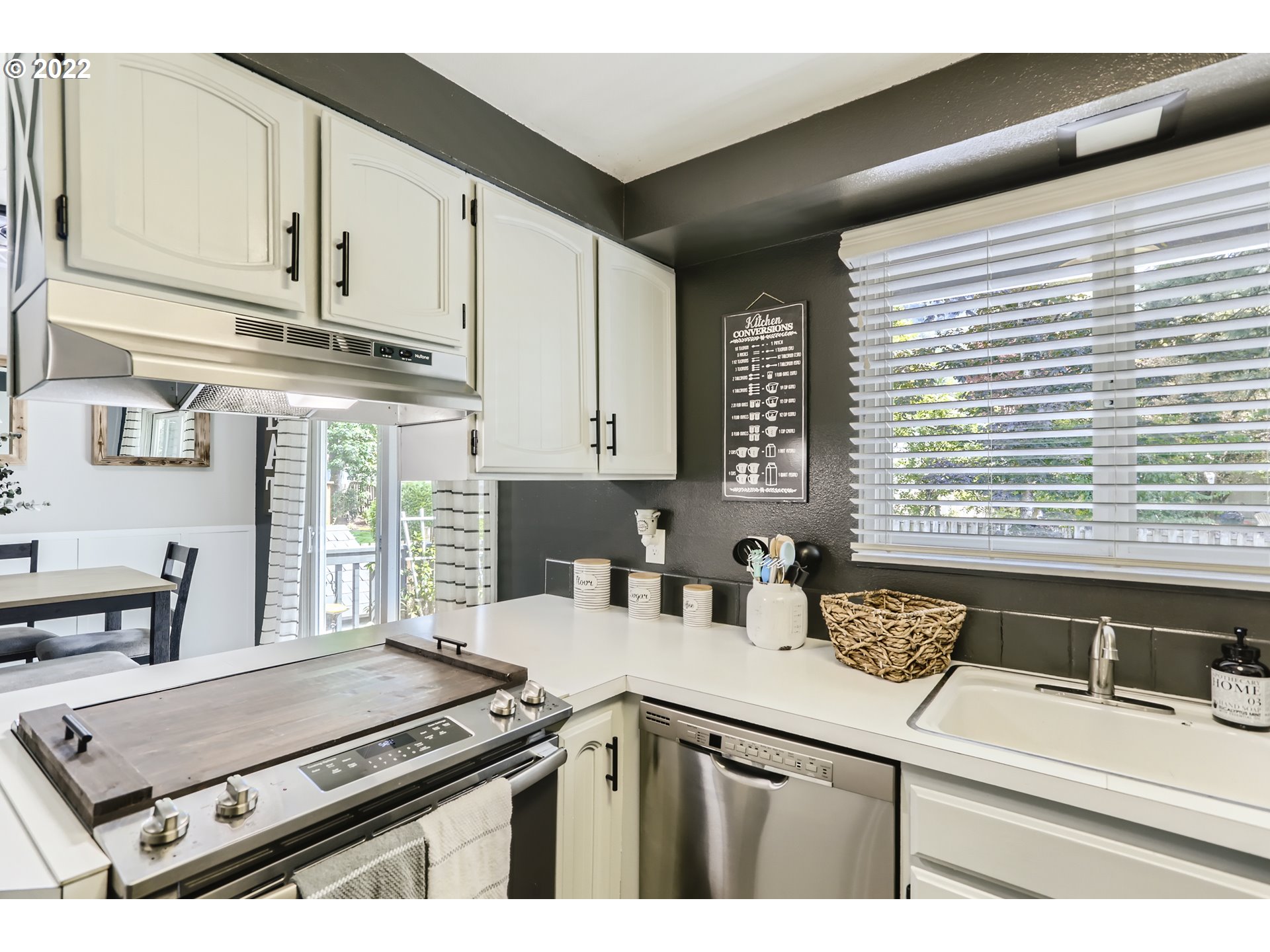 490 Southwest 4th Street Gresham, OR 97080 - Photo 12 of 30 a kitchen with stainless steel appliances sink cabinets and window