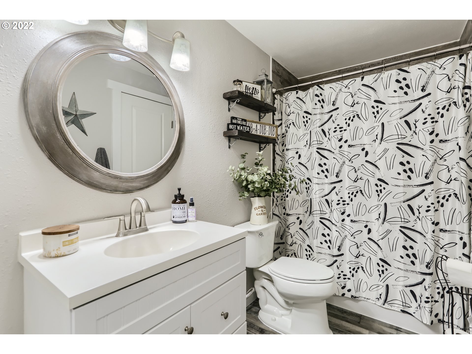 490 Southwest 4th Street Gresham, OR 97080 - Photo 19 of 30 a bathroom with a sink toilet mirror and shower