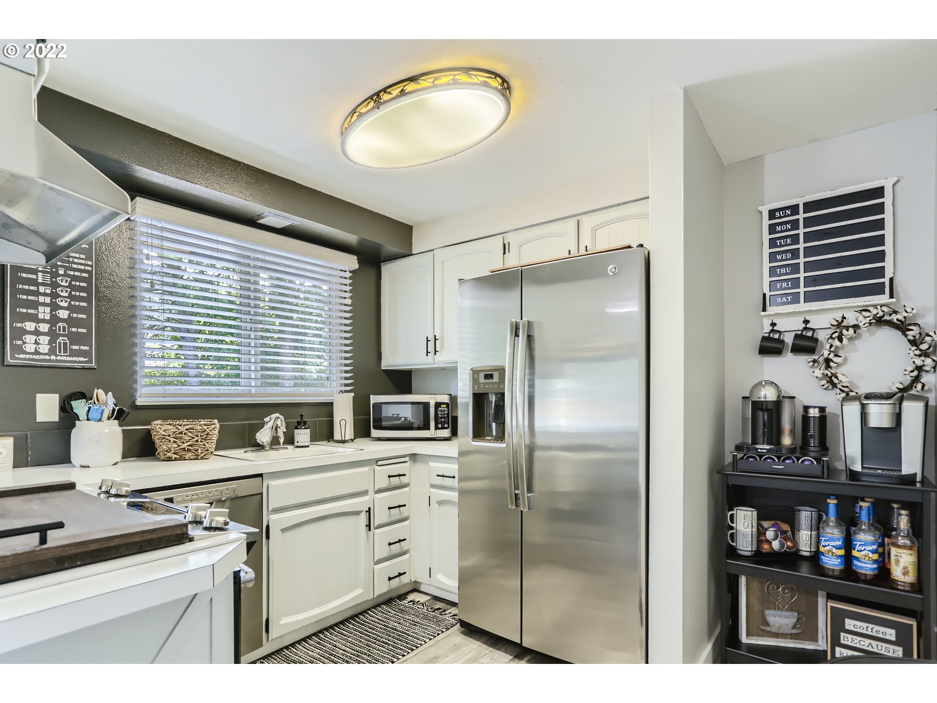 490 Southwest 4th Street Gresham, OR 97080 - Photo 10 of 30 a kitchen with stainless steel appliances a refrigerator sink and cabinets