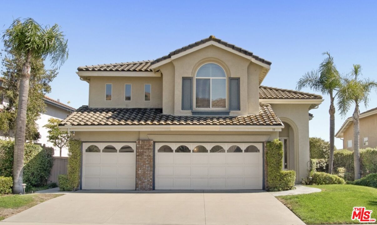 59 La Perla Foothill Ranch, CA 92610 - Photo 1 of 60 a front view of a house with a yard and garage