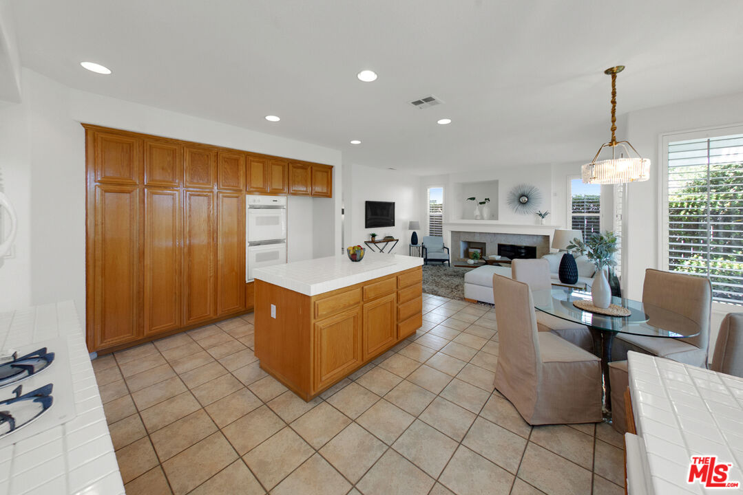 59 La Perla Foothill Ranch, CA 92610 - Photo 21 of 60 a large white kitchen with a large window
