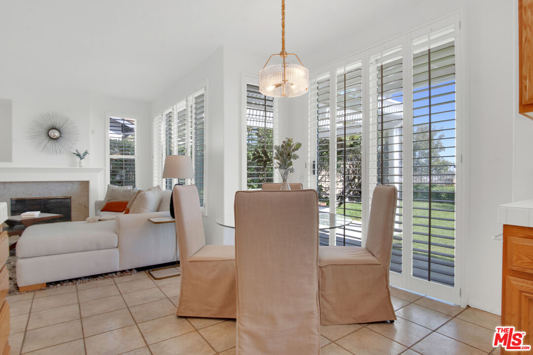 59 La Perla Foothill Ranch, CA 92610 - Photo 23 of 60 a living room with furniture a lamp and a chandelier