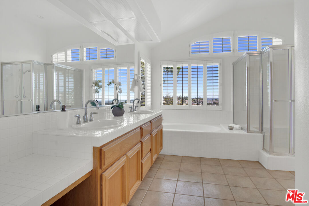 59 La Perla Foothill Ranch, CA 92610 - Photo 30 of 60 a bathroom with a bathtub sink and mirror
