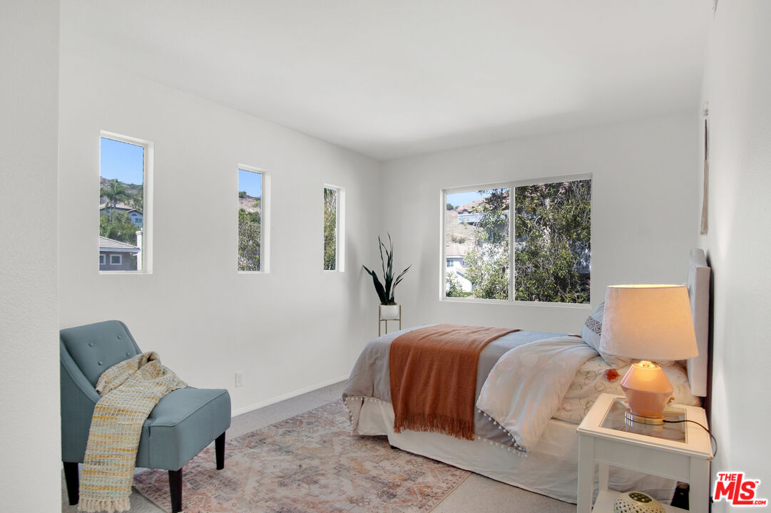 59 La Perla Foothill Ranch, CA 92610 - Photo 38 of 60 a bedroom with a bed and chair
