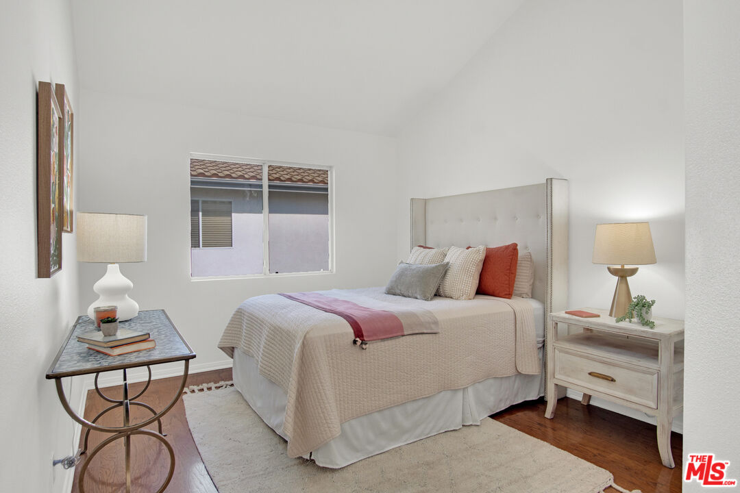 59 La Perla Foothill Ranch, CA 92610 - Photo 39 of 60 a bedroom with a bed and wooden floor