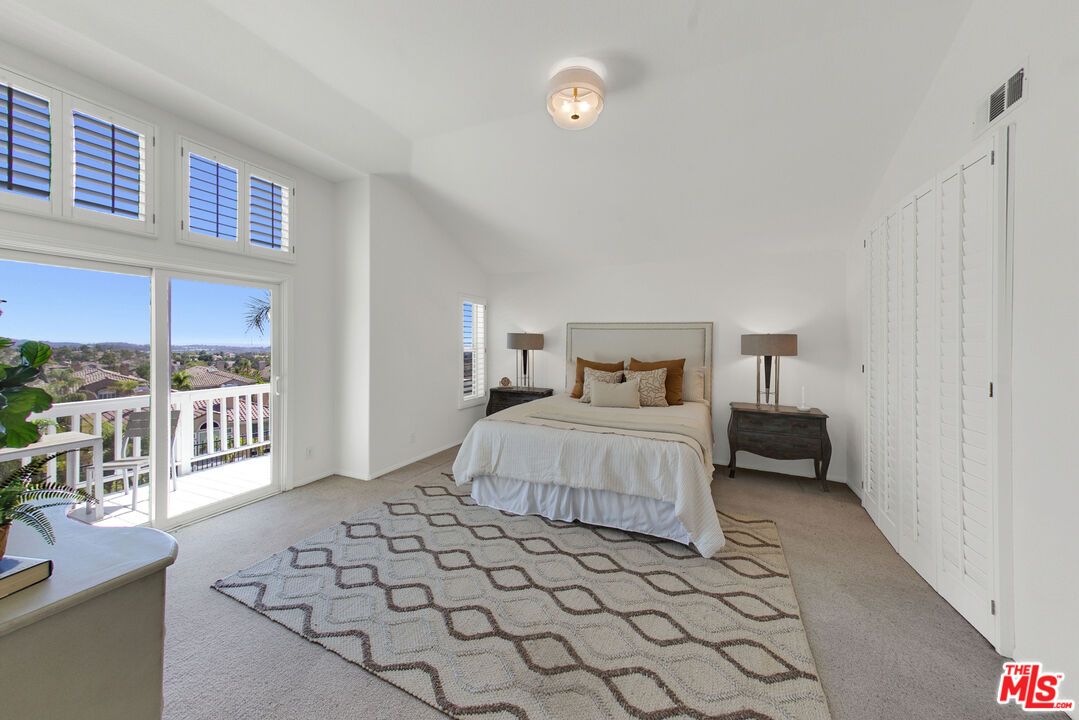 59 La Perla Foothill Ranch, CA 92610 - Photo 41 of 60 a bedroom with a bed and a night stand