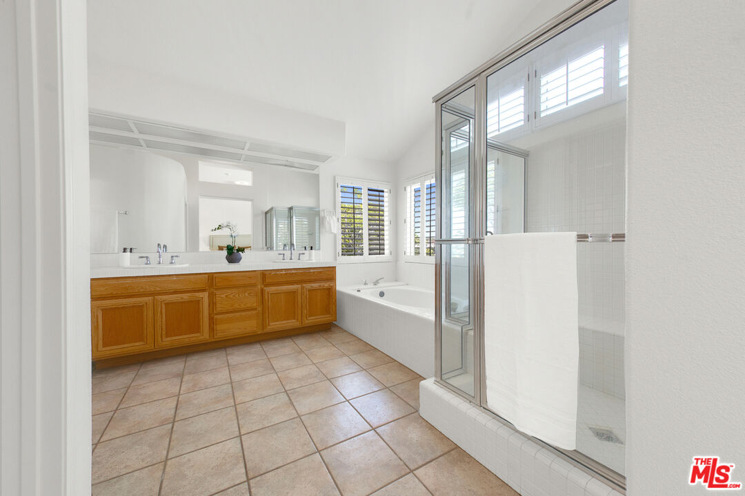 59 La Perla Foothill Ranch, CA 92610 - Photo 46 of 60 a large white bathroom with a double vanity sink a mirror and a bathtub