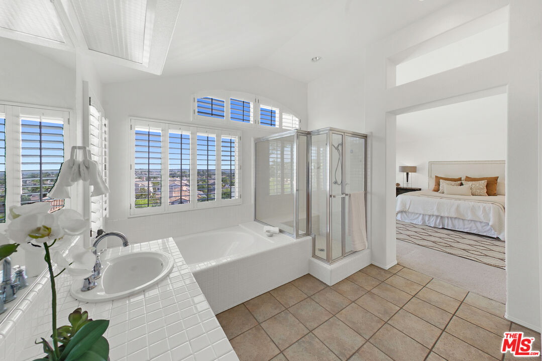 59 La Perla Foothill Ranch, CA 92610 - Photo 47 of 60 a spacious bathroom with a tub sink and mirror