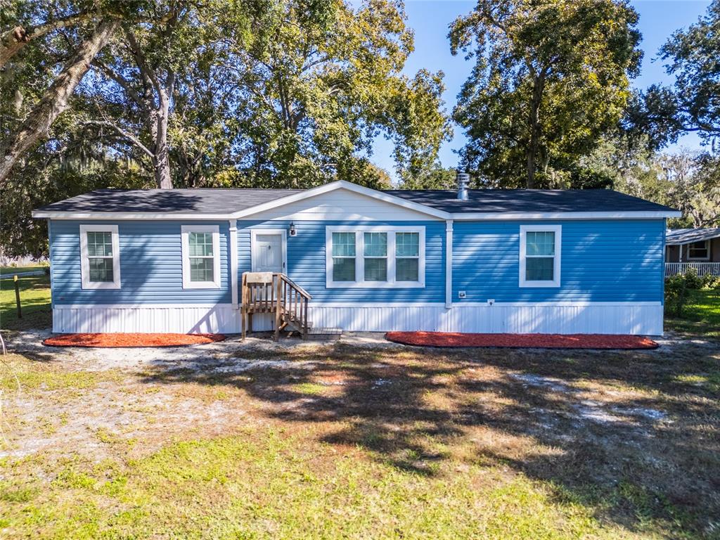689 Eagle Watch Road Oak Hill, FL 32759 - Photo 1 of 32 a front view of a house with a yard
